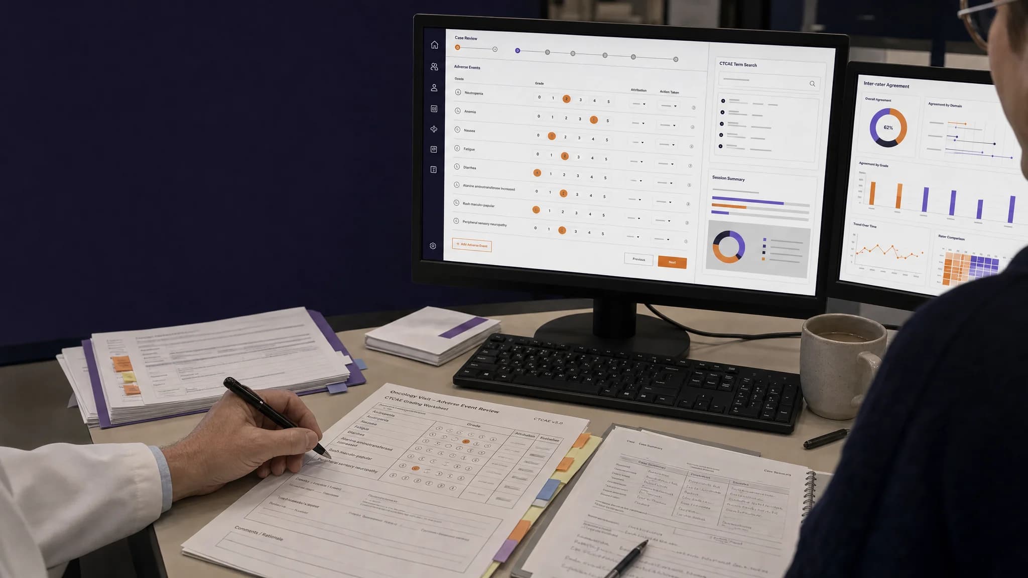 A person with a pen reviews printed documents while a computer screen displays charts and data metrics.